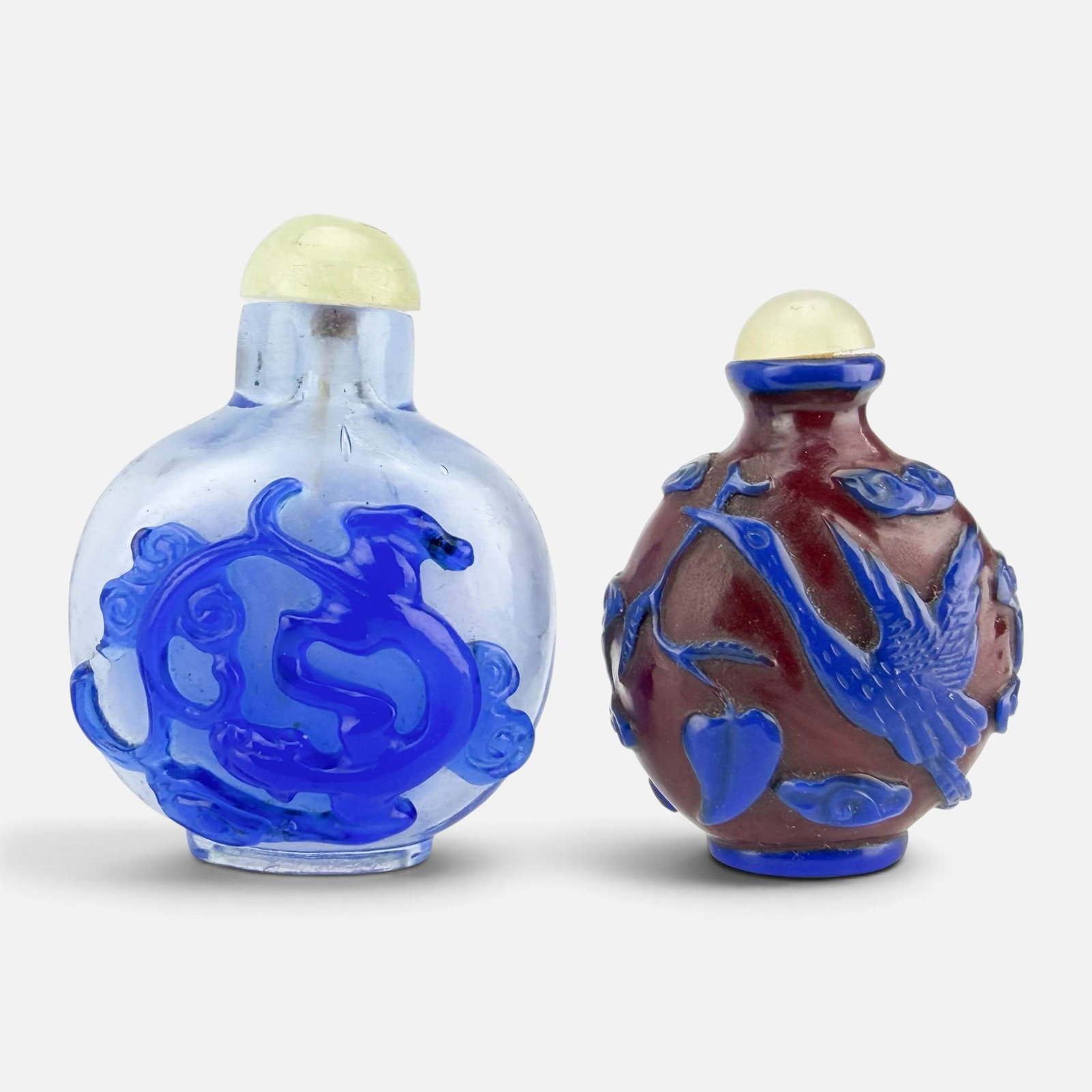 Two Chinese Peking Glass Overlay Snuff Bottles w/Chilong & Swan Carving: Very good condition, with some very minor edge roughness to lids. No chips, breaks, or repairs. Larger bottle measures approx. H: 2 7/8", W: 2", D: 1 1/2", smaller bottle measures approx. H: 2 1/2",