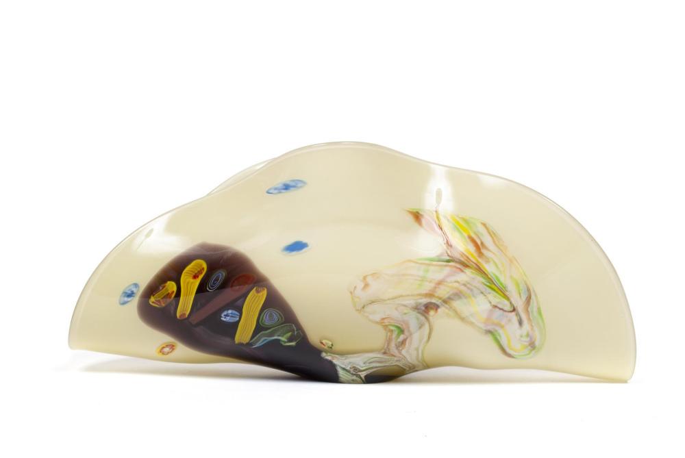 HUAN WANG ART GLASS VESSEL: HUAN WANG ART GLASS VESSEL Abstract design formed with fold to the open center in shades of brown, yellow, blue and green on beige ground, signed to underside. 7.5" height, 17.25" length