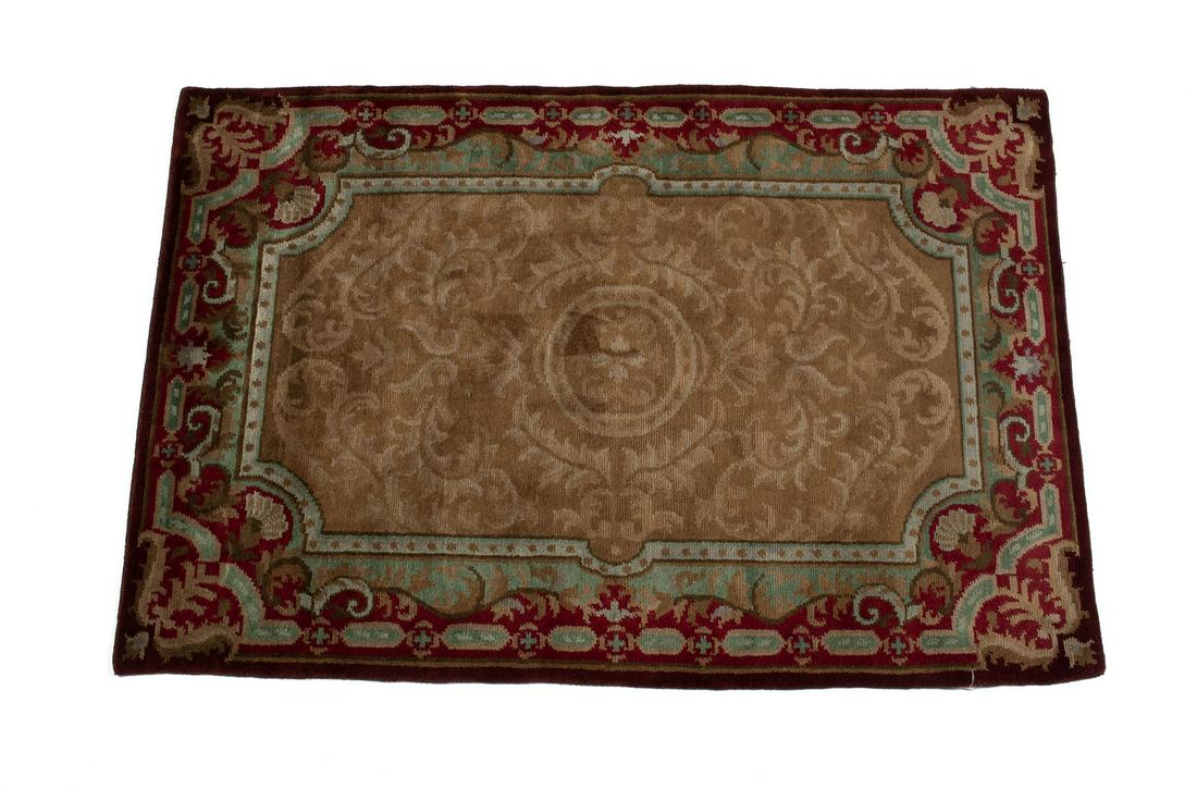 SAVONERY DESIGN AREA RUG: Twentieth century, wool. Fading foliate beige field with celadon and red border. 4'1" length, 5'11" width