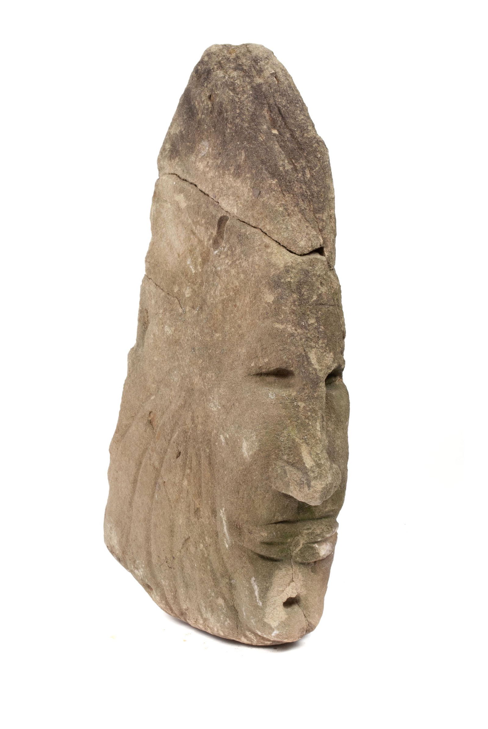 FOLK ART STONE CARVING OF NATIVE AMERICAN HEAD: FOLK ART STONE CARVING OF NATIVE AMERICAN HEADAmerican, late 19th/early 20th century. Stone carving depicting a Native American head with headdress. Showing cracks and repairs to headdress; field foun