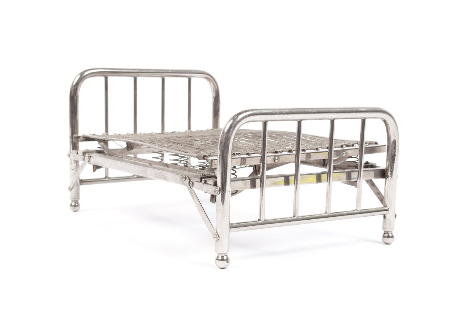 AMERICAN SALESMAN SAMPLE FOLDING BED: AMERICAN SALESMAN SAMPLE FOLDING BED Circa 1930, nickel plated brass collapsible bed frame with springs. 5.25" height, 10.25" length, 6.5" width