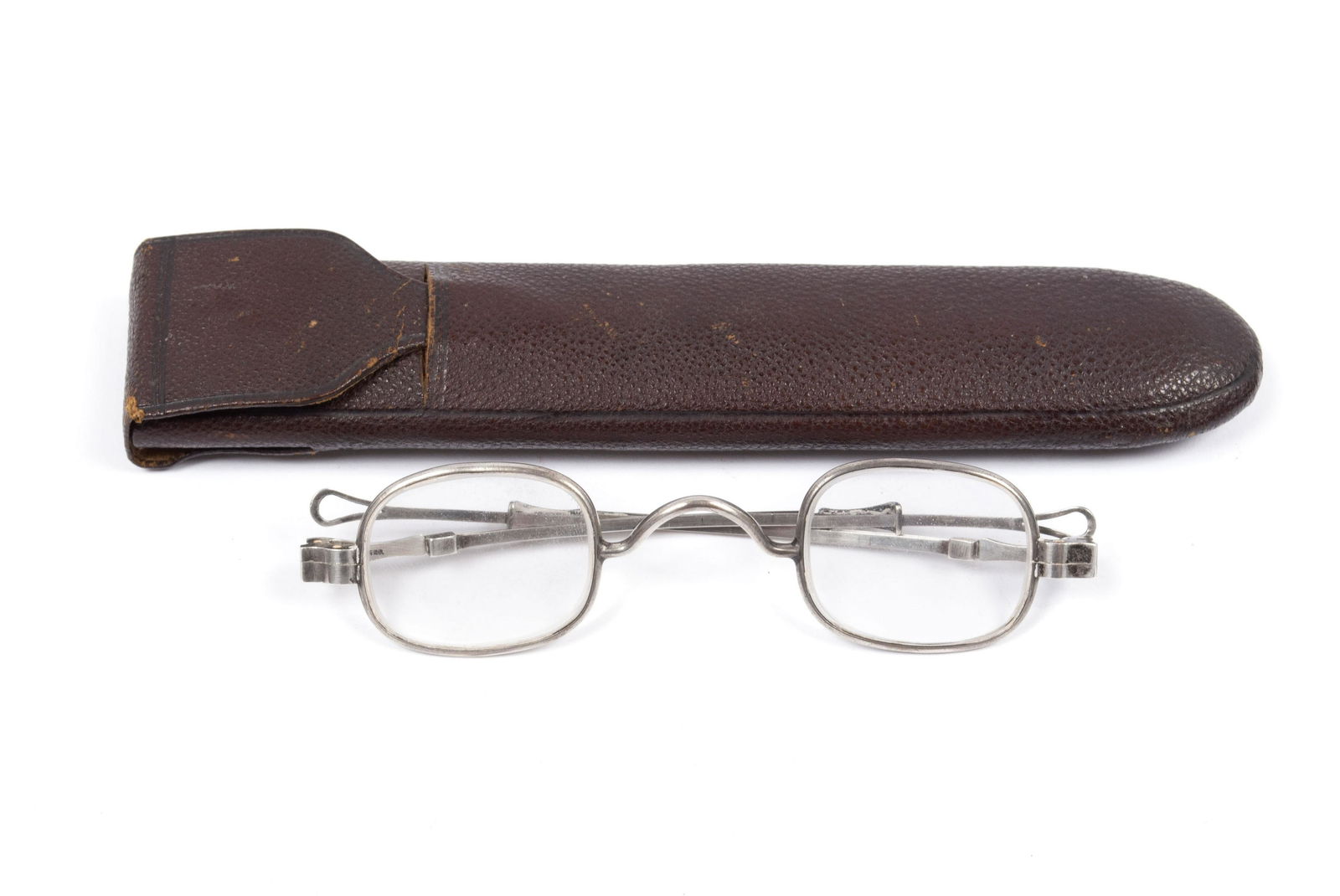 PAIR OF ANTIQUE ADJUSTABLE SPECTACLES: PAIR OF ANTIQUE ADJUSTABLE SPECTACLESAmerican, mid-19th century, coin silver sliding spectacles by McAllister in leather case retailed by Widdifield & Co, Boston.