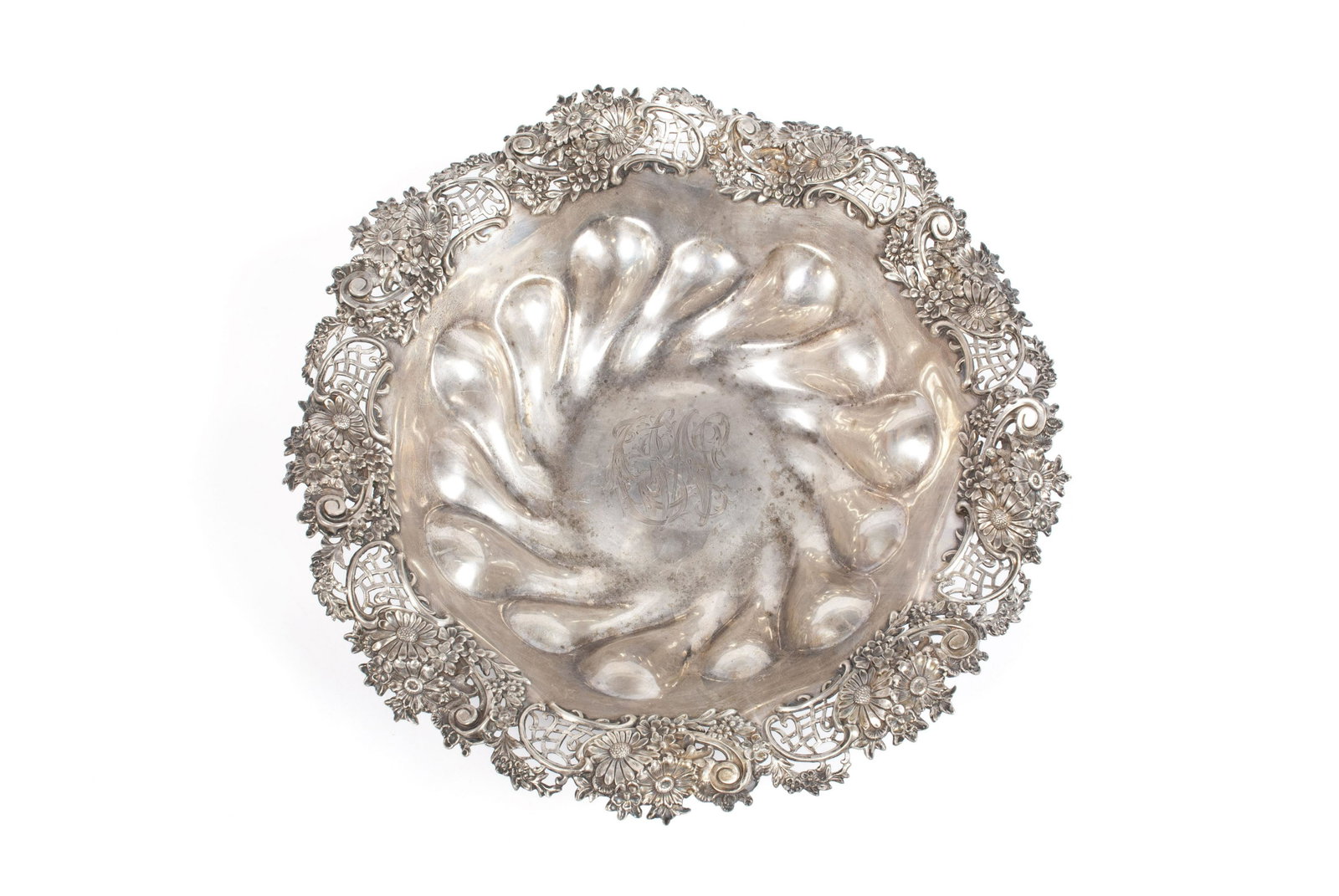 SILVER BOWL: SILVER BOWL American, ca. 1899. Sterling silver bowl with elaborate pierced Rococo and foliate decorated rim. Bottom marked as retailed by "E. Jaccard Jewelry Co." with etched date of "1899". Interior