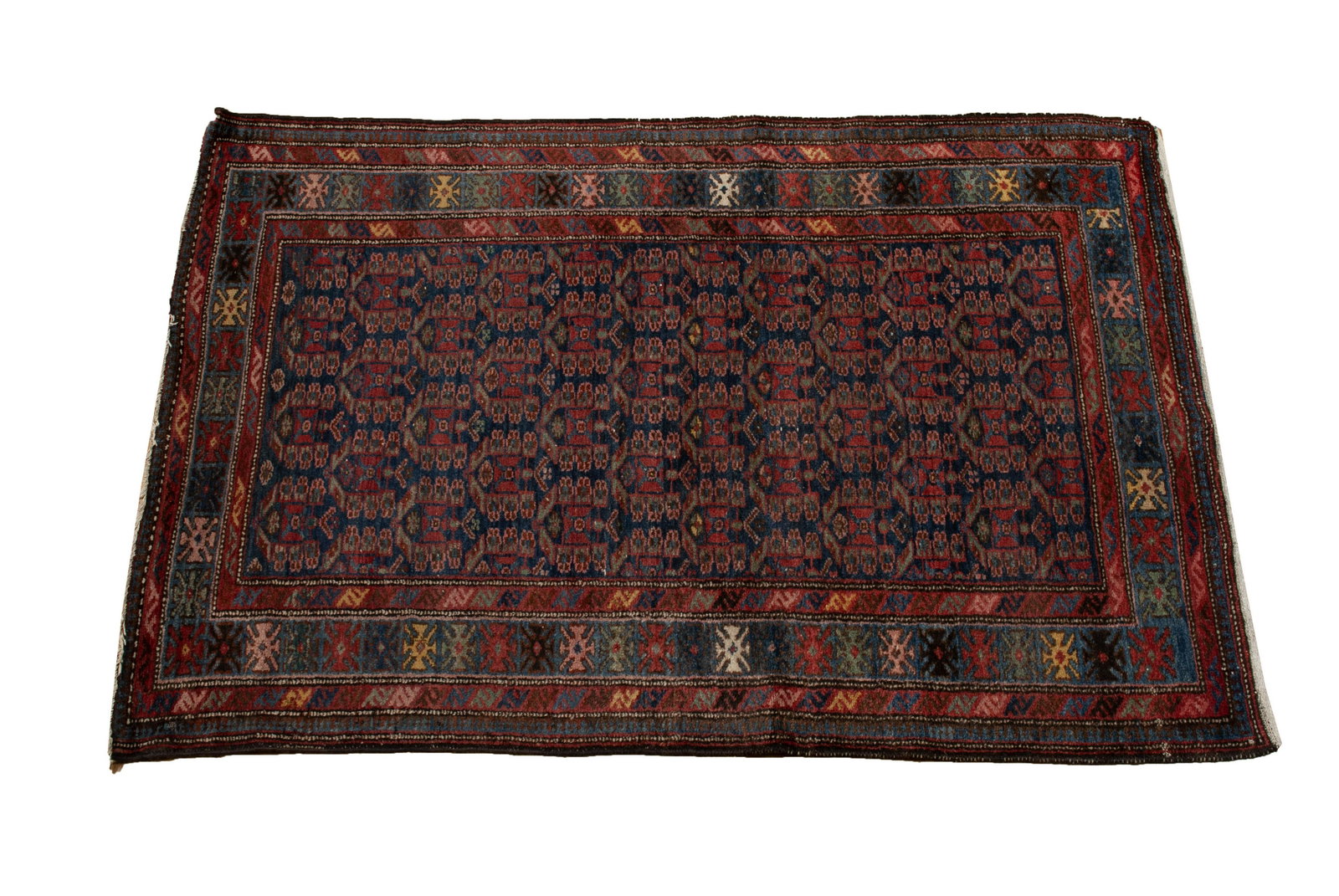 HAMADAN AREA RUG: HAMADAN AREA RUG Persian, ca.1920s. Repetitive rows of green and red medallions cover the navy field, with geometric decorated blue border and red guard borders. 6' 4" length, 4' 2" width