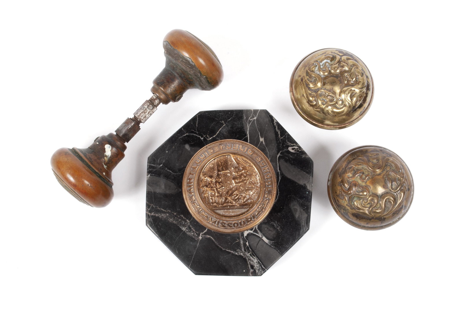 FIVE DOORKNOBS: FIVE DOORKNOBS American, early 20th century. One a pictorial brass knob mounted on black marble base is marked "SAINT LOUIS PUBLIC SCHOOLS - MISSOURI" around an image of a teacher teaching. Pair of br