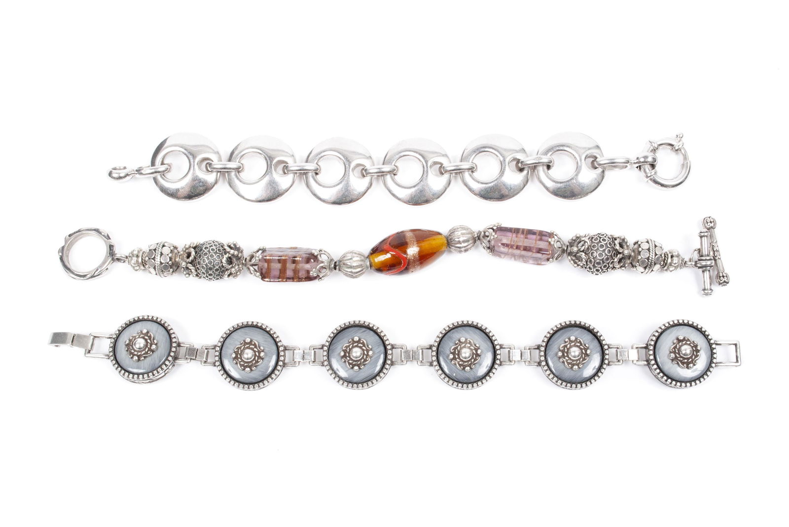 THREE STERLING BRACELETS: THREE STERLING BRACELETSContinental, 20th century. Murano glass example with two (2) other medallion link bracelets, all stamped 925. 137 grams