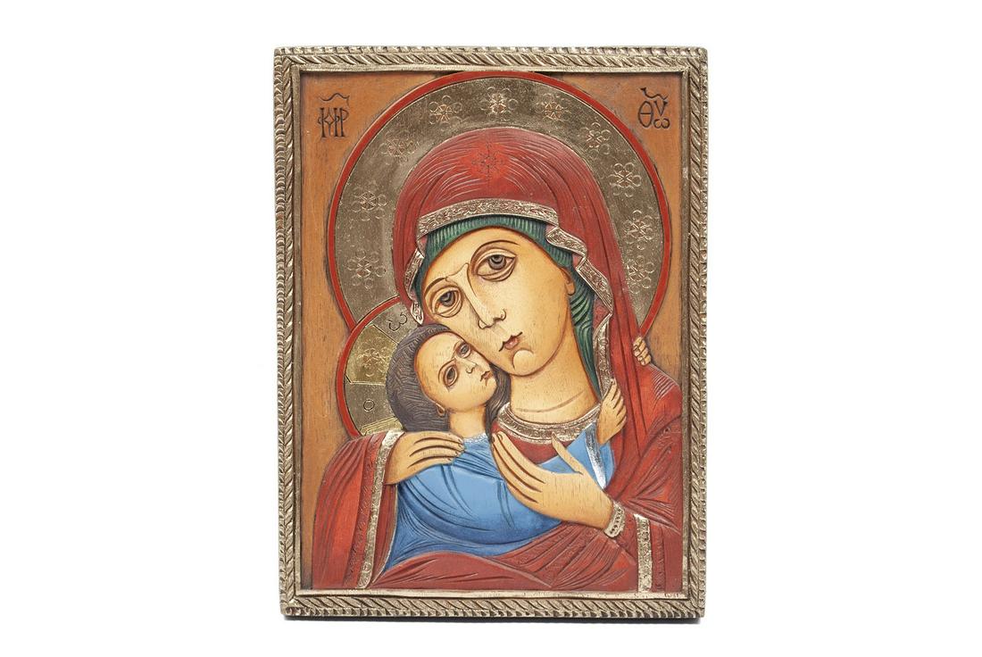 WOODEN ICON OF MADONNA AND CHILD: WOODEN ICON OF MADONNA AND CHILDRussian, mid 20th century. Lacquered wood with relief carving, gilt highlights to clothing and to halos of subjects. 11" height, 8.25" width