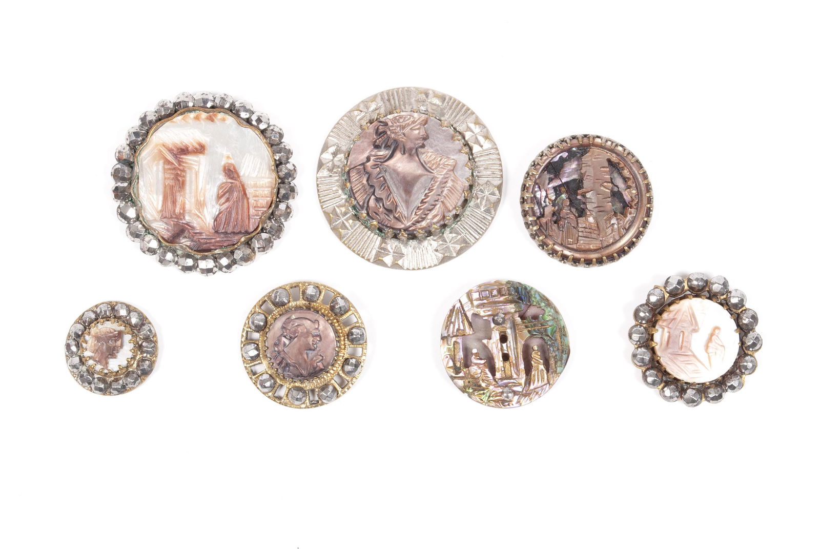ASSORTMENT OF PEARL DIVISION I BUTTONS: ASSORTMENT OF PEARL DIVISION I BUTTONSCarved mother of pearl, abalone shell, seven (7) total; OME steel accents, cameos and landscapes; multiple piece buttons.