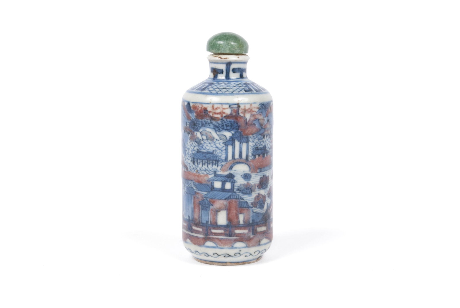 CHINESE YONGZHENG PORCELAIN SNUFF BOTTLE: CHINESE YONGZHENG PORCELAIN SNUFF BOTTLE Cylindrical form with city and garden scene, rust-colored accents, and jadeite stopper; cobalt underglaze meandering border mark to underside.Provenance: Estat