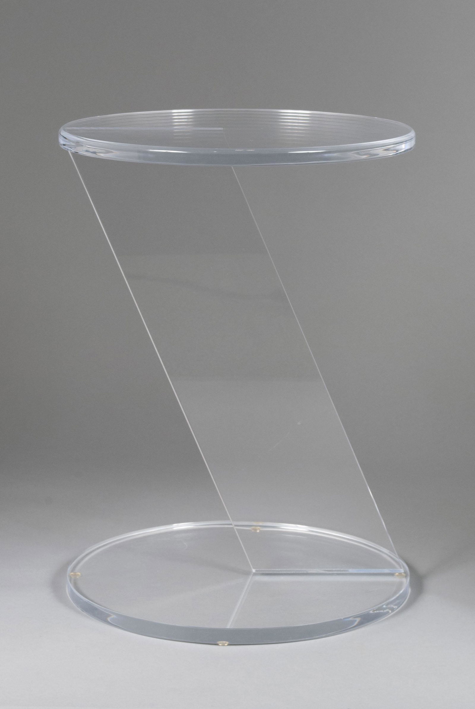 HIVO VAN TEAL (20TH CENTURY): HIVO VAN TEAL (20TH CENTURY)Lucite. Drinks table with circular top and base connected by a flat geometric angled support. 21.5" height, 16.25" diameter