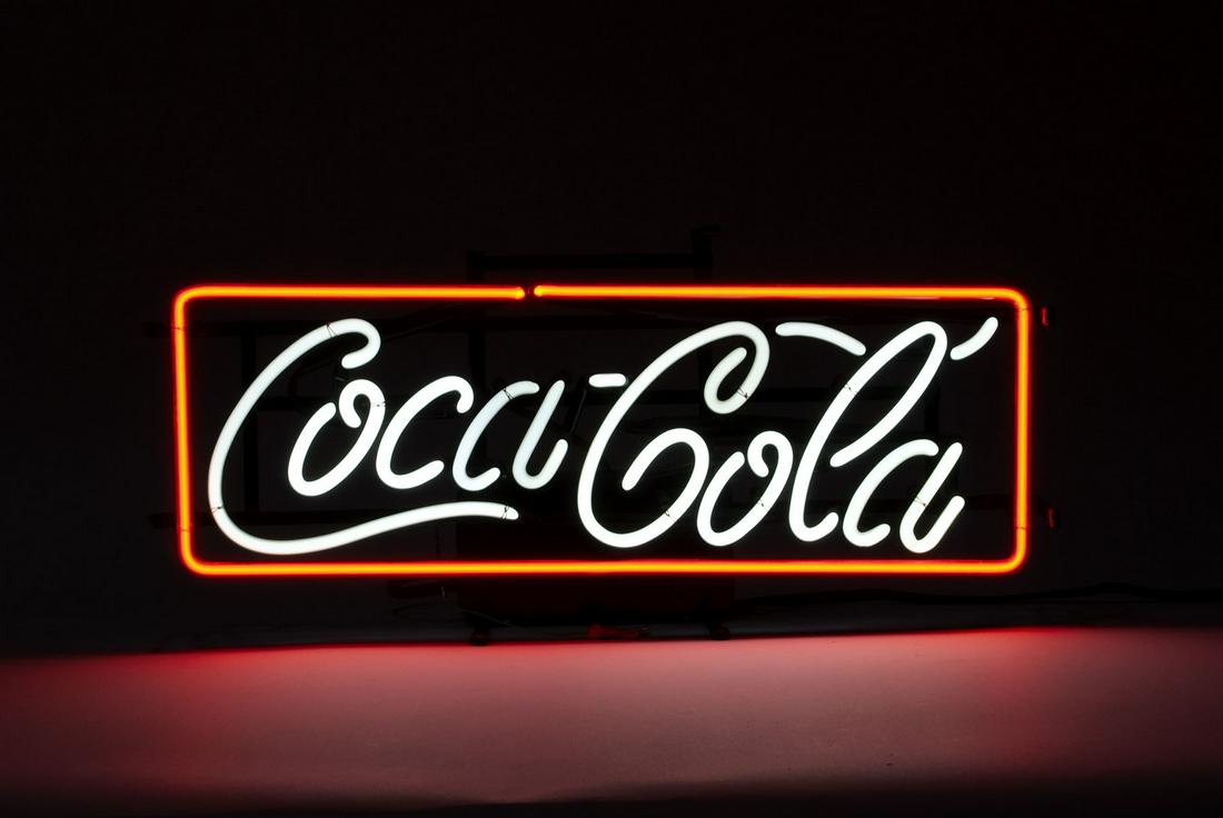 COCA-COLA NEON ADVERTISING SIGN: COCA-COLA NEON ADVERTISING SIGN Wall mountable advertising piece in good, operable condition - script illuminating white. 10.5" height, 23.25" length