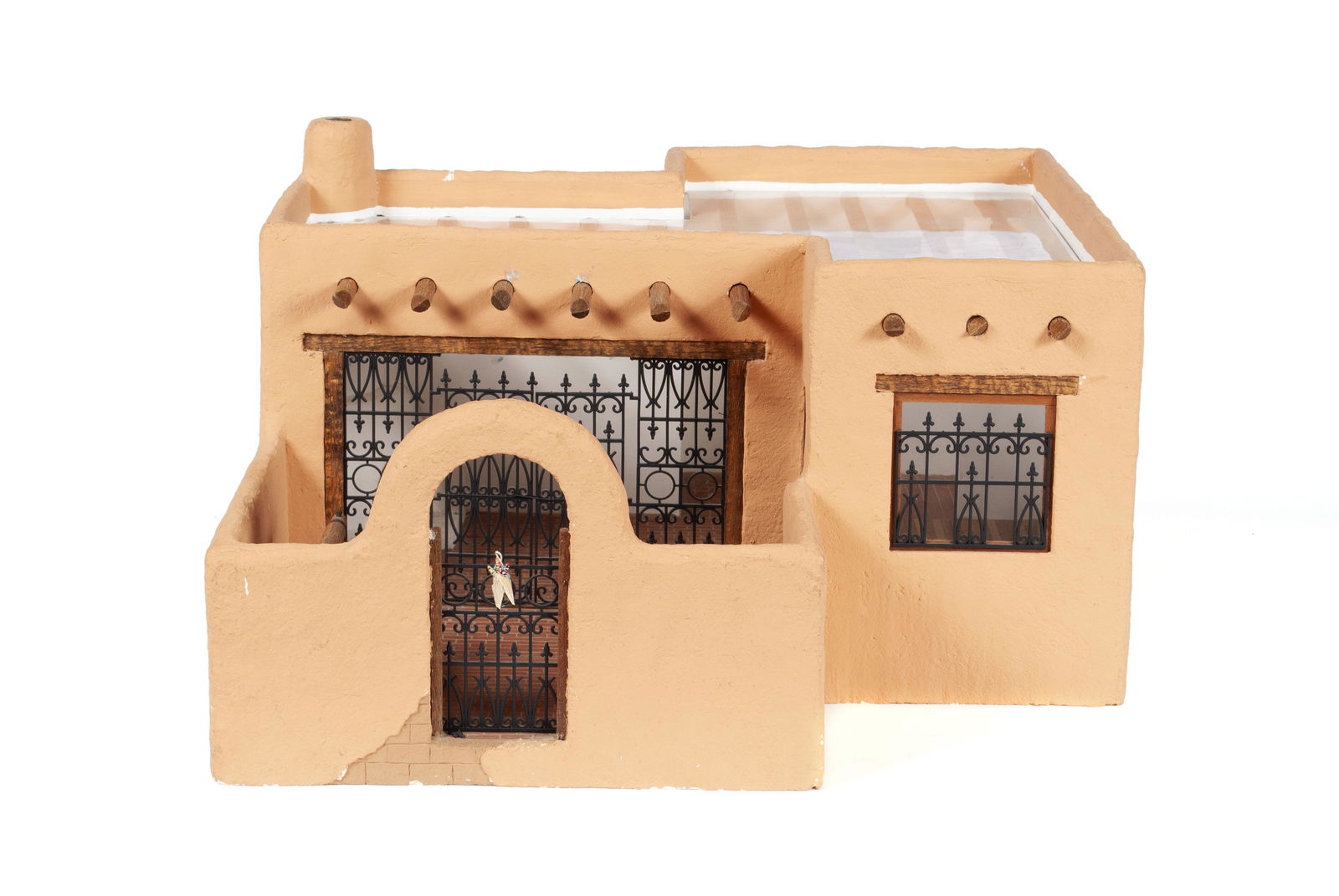 HAROLD LOVELADY ADOBE DOLLHOUSE: HAROLD LOVELADY ADOBE DOLLHOUSEHandmade Southwest style pueblo house with brick laid floor leading to outdoor patio with installed water well; additionally outfitted with intricate gate-work, built-in