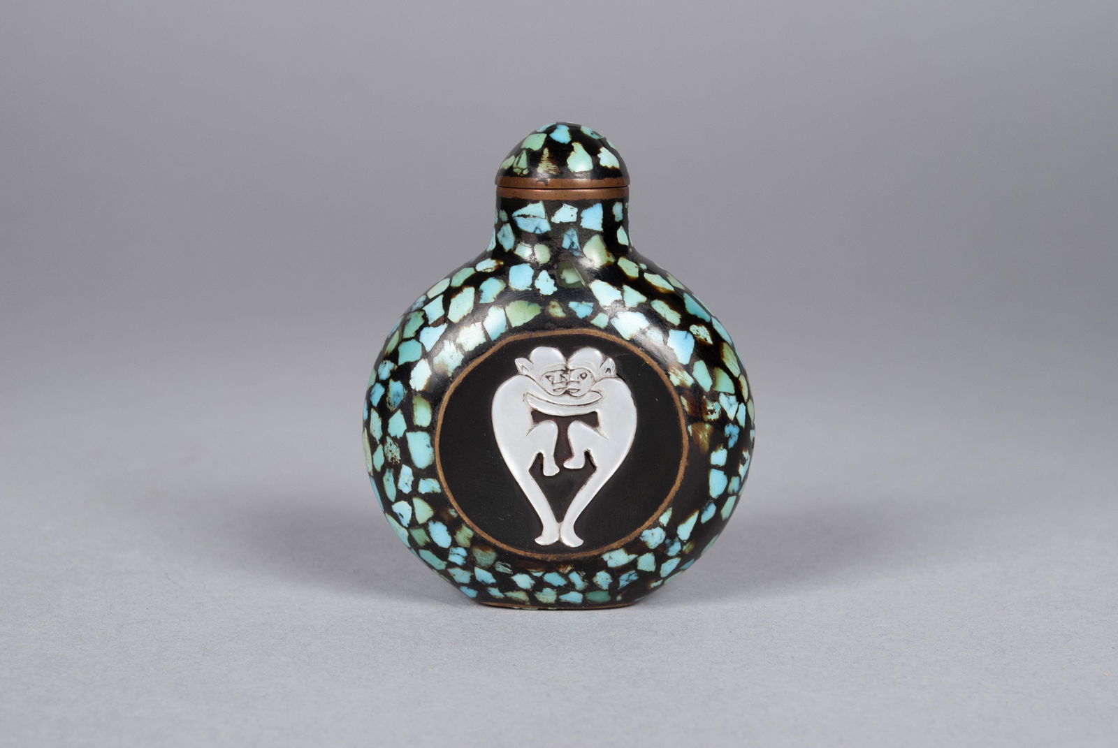 UNUSUAL DOUBLE MONKEY SNUFF BOTTLE: UNUSUAL DOUBLE MONKEY SNUFF BOTTLELikely China, late 19th- early 20th century. Turquoise-infused lacquer, abalone decoration of embracing monkeys to one side and elephant to verso, possibly early Art