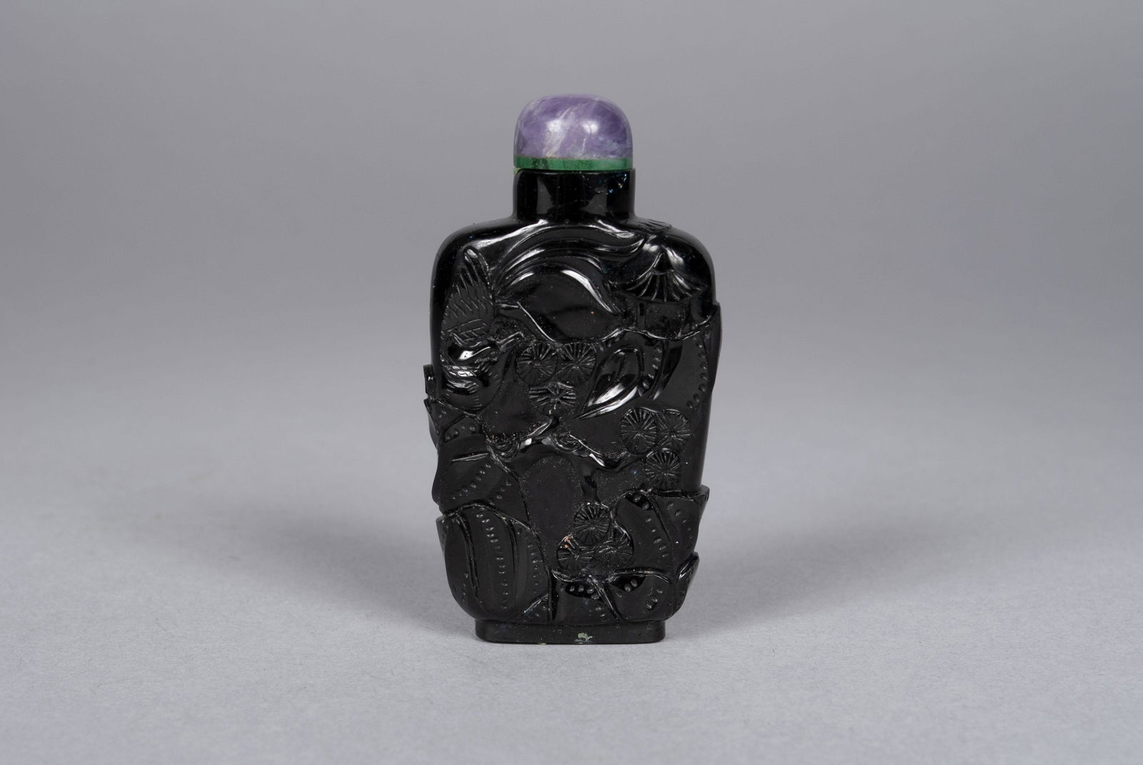 WELL-CARVED LABRADORITE SNUFF BOTTLE: WELL-CARVED LABRADORITE SNUFF BOTTLEChina, mid-19th- early 20th century. Amethyst stopper collared with malachite inserts to high-shouldered, tapering wall bottle finely carved with birds in pines. 2.