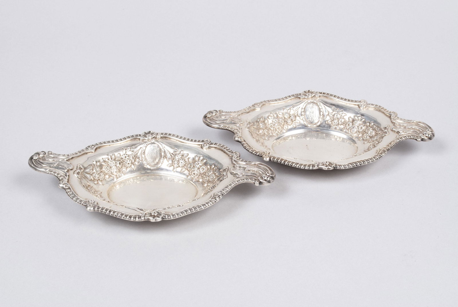 PAIR OF ENGLISH STERLING SERVING DISHES: PAIR OF ENGLISH STERLING SERVING DISHESEngland, hallmarked for Charles Stuart Harris, London, 1896, pair of repousse dishes, monogrammed. 9.4" length, 475 grams