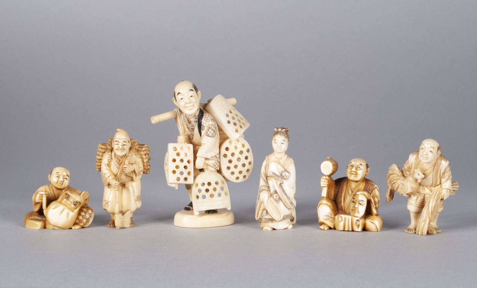 SMALL COLLECTION OF NETSUKE AND OKIMONOS: SMALL COLLECTION OF NETSUKE AND OKIMONOS Six total well-carved figures with incised decorations. Consisting of an okimono basketry peddler on stand, and another smaller okimono of a farmer with rooste