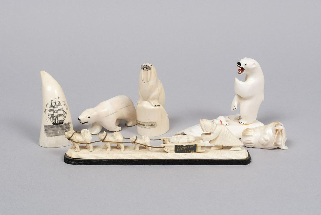 SIX FOSSIL AND BONE INUIT CARVINGS: SIX FOSSIL AND BONE INUIT CARVINGSIncludes a dog sled group, two polar bears, two walrus and a scrimshaw tooth. One walrus carving is a tooth signed by "Wm. Luke", 4" height. Longest: 8.5" length
