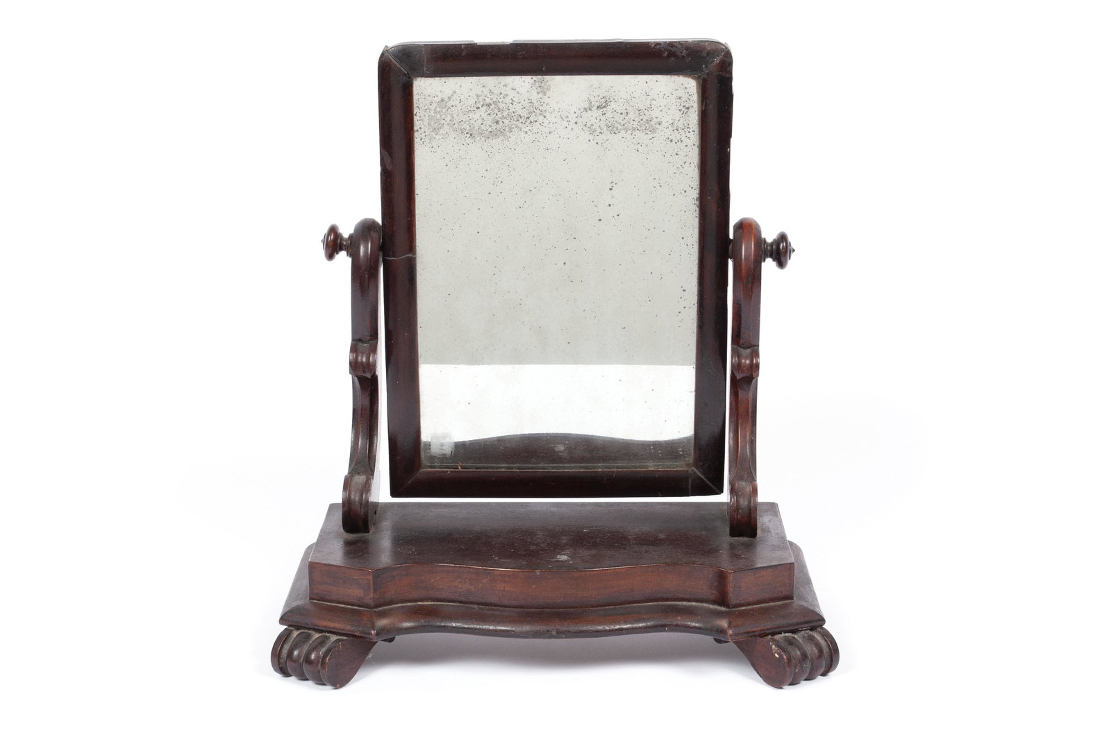 DRESSER TOP SHAVING MIRROR: DRESSER TOP SHAVING MIRROR American, 19th century. Revolving rectangular looking glass on end supports, serpentine base. 19" height, 17.25" width, 9.5" depth