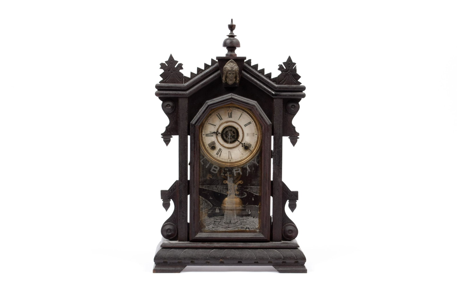LIBERTY MANTEL CLOCK: LIBERTY MANTEL CLOCK American, late 19th century. An 8-day clock in architectural case, the front glazed door decorated with the Statue of Liberty and "LIBERTY" across the front. 24" height