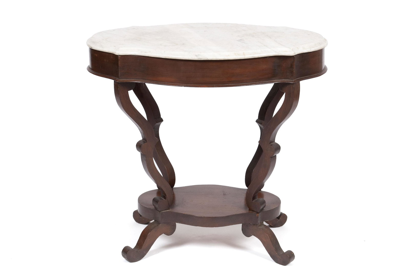 TURTLE TOP VICTORAIN CENTER TABLE: TURTLE TOP VICTORAIN CENTER TABLE American, 19th century. White marble top above the conforming frieze, on four scrolling supports with medial shelf/stretcher below. 29" height, 21" width, 31" depth
