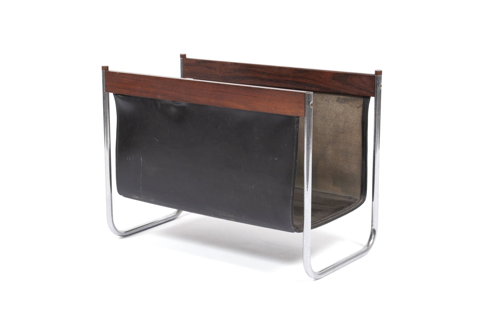 MANNER OF MIES VAN DER ROHE LEATHER MAGAZINE RACK: MANNER OF MIES VAN DER ROHE LEATHER MAGAZINE RACK Dark leather sling rack stretched between chrome bracket legs. 16.25" height, 22" length, 12" width