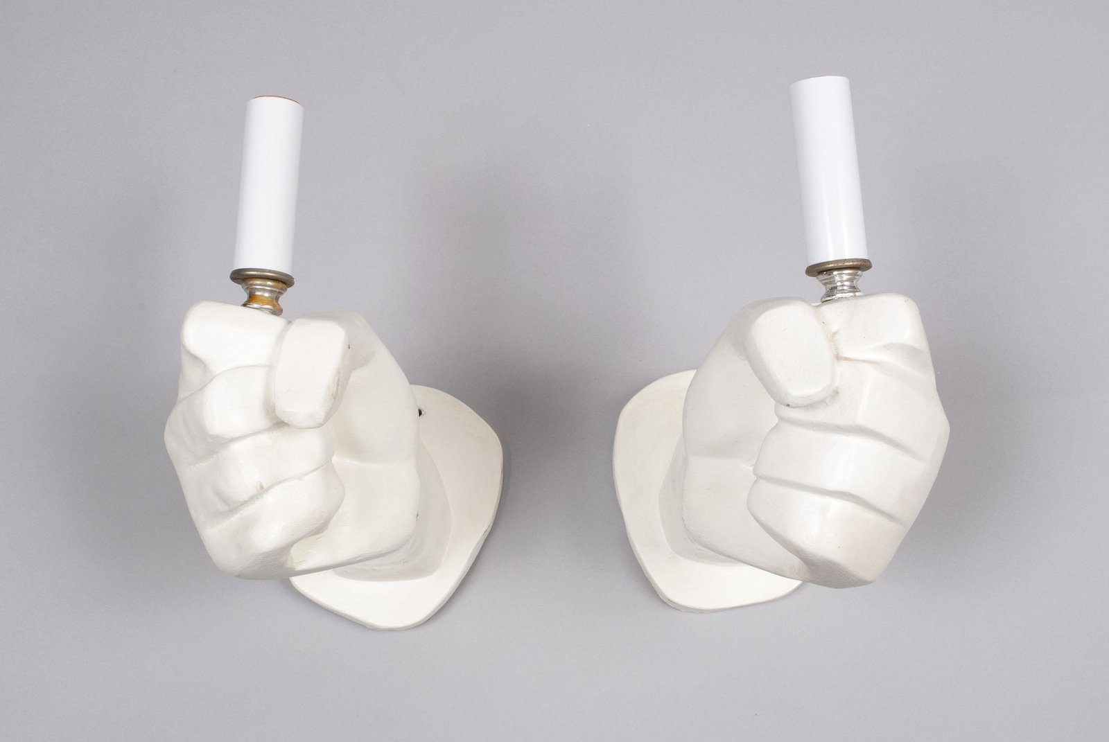PAIR OF RETRO CARVED FIST SCONCES: PAIR OF RETRO CARVED FIST SCONCES Carved and painted wooden fist forms, wall-attachable, gripping candle-form bulbs. 12" length