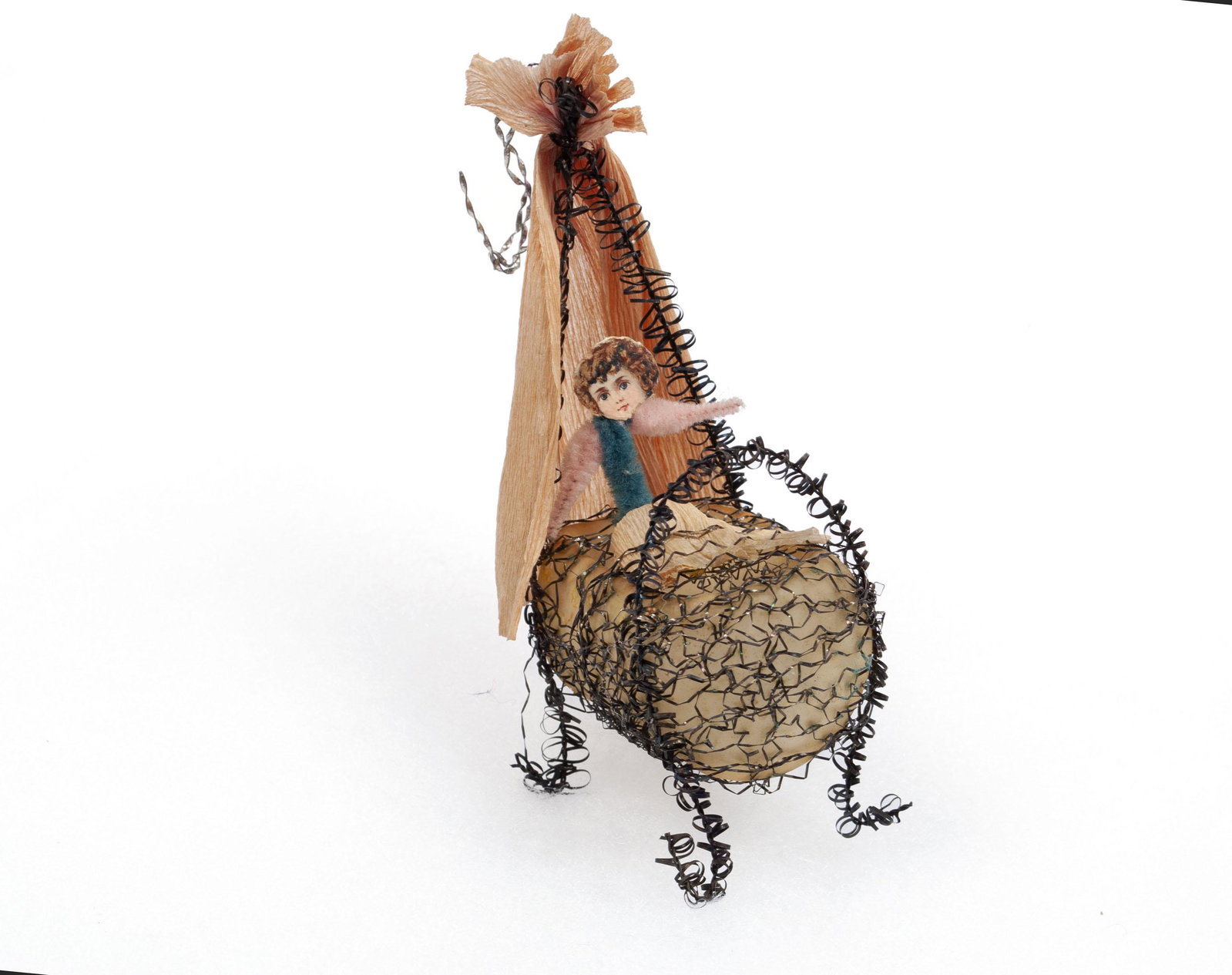 SEBNITZ CHRISTMAS ORNAMENT: SEBNITZ CHRISTMAS ORNAMENT Germany, pre-1950. Constructed of scrap with a baby in a cradle. 5" height