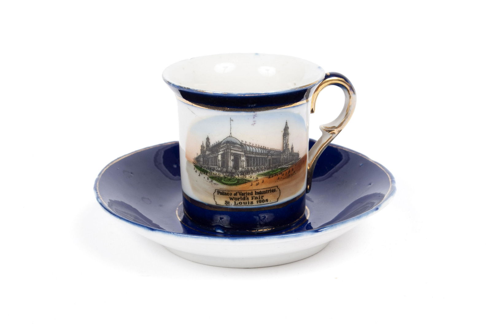 1904 ST. LOUIS WORLD'S FAIR DEMITASSE PORCELAIN: 1904 ST. LOUIS WORLD'S FAIR DEMITASSE PORCELAINGerman, diminutive cobalt and gilt decorated teacup and saucer, the cup with color transfer of the Palace of Varied Industries above text: "Expo of St. L