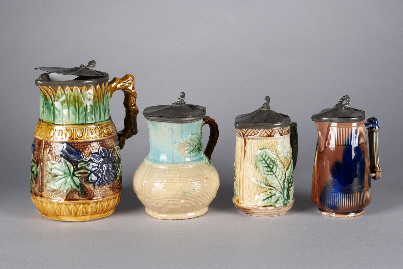FOUR MAJOLICA PITCHERS (1 of 5)