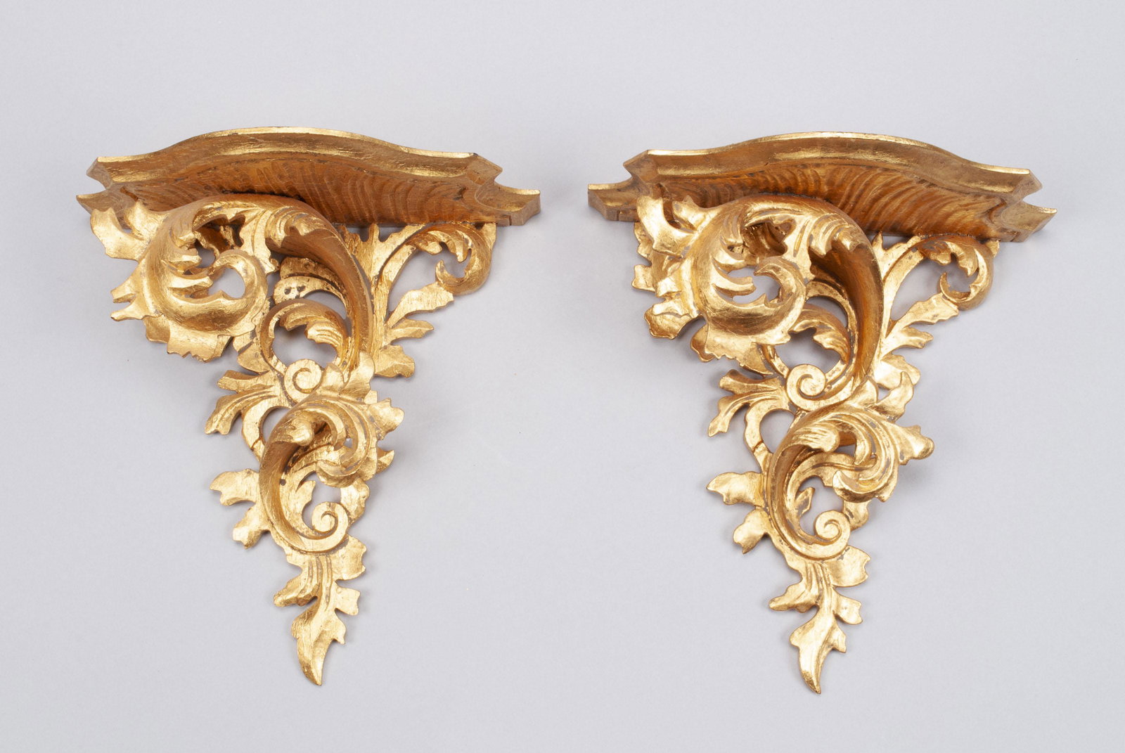 PAIR OF CARVED GILTWOOD FLORENTINE WALL BRACKETS: PAIR OF CARVED GILTWOOD FLORENTINE WALL BRACKETS Italian, well-carved foliate forms. 11" height, 10" width