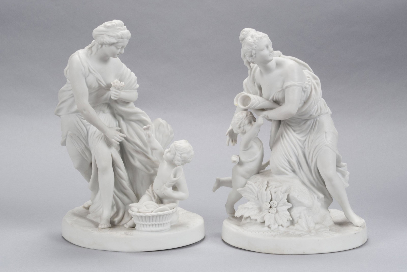 PAIR OF PARIAN FIGURES: PAIR OF PARIAN FIGURESContinental, early 20th century. Each showing a maiden with cherub, bisque finish. Tallest 8.5" height