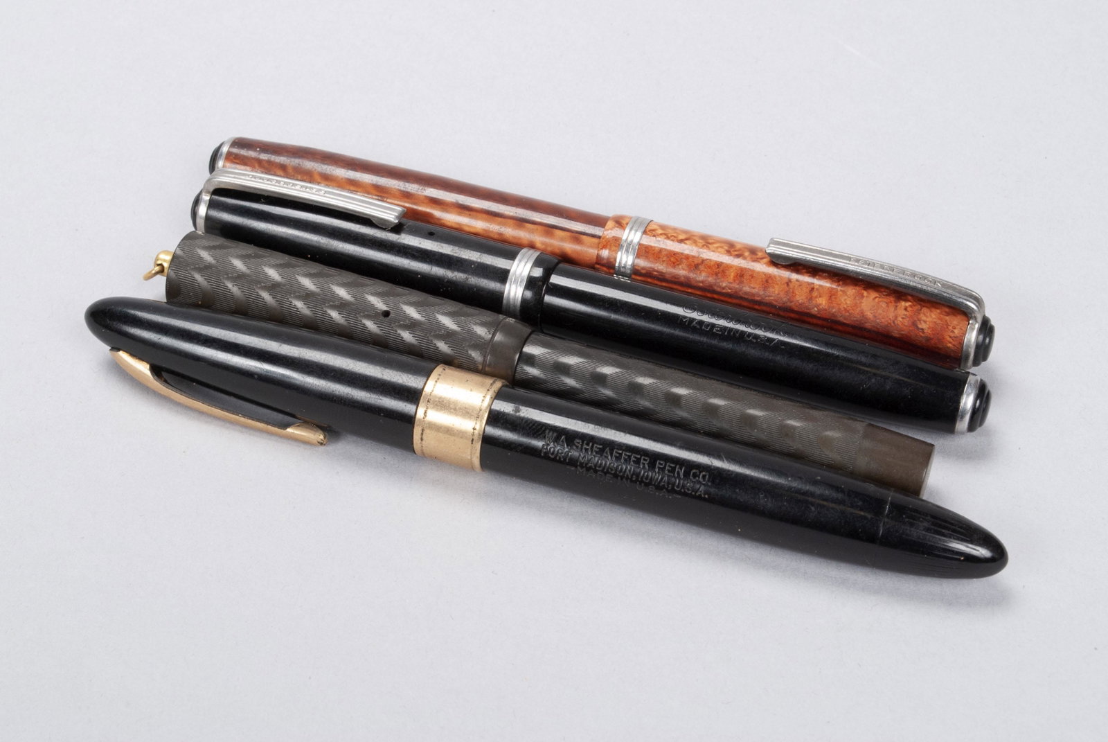 COLLECTION OF ANTIQUE PENS: COLLECTION OF ANTIQUE PENS Schaefer's 14k gold tip Lifetime in black, Schaefer 2 self-filling, Esterbrook 2314B in copper, and Esterbrook 2284 in black.