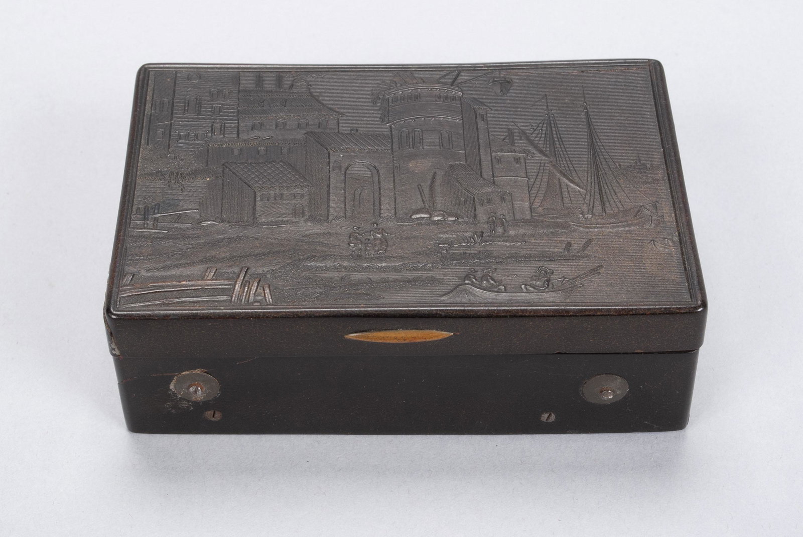 TORTOISESHELL MUSIC BOX: TORTOISESHELL MUSIC BOXSmall, hinged form with riverside cityscape in relief to lid, transparent amber interior revealing mechanism. 3.5" length, 2.25" width, 1.25" depth