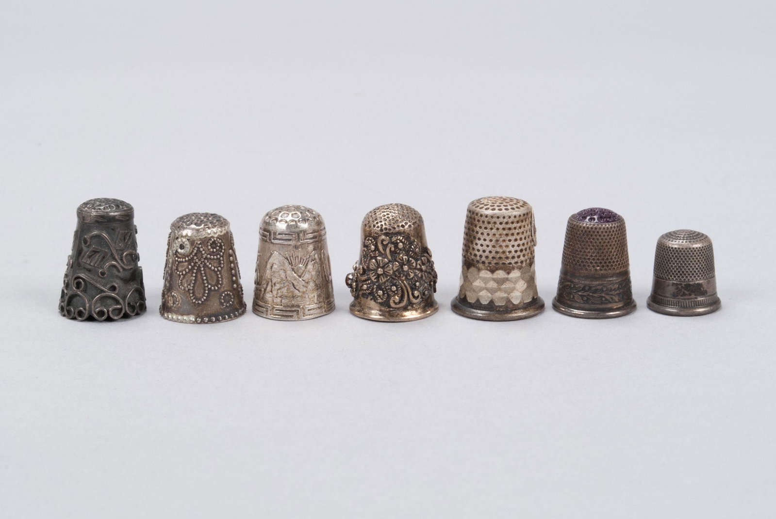 STERLING SILVER THIMBLES: STERLING SILVER THIMBLES Various origins, late 19th to mid-20th century. British example marked 8 and anchor, JDR Taxco, and American examples, all marked. 39 grams