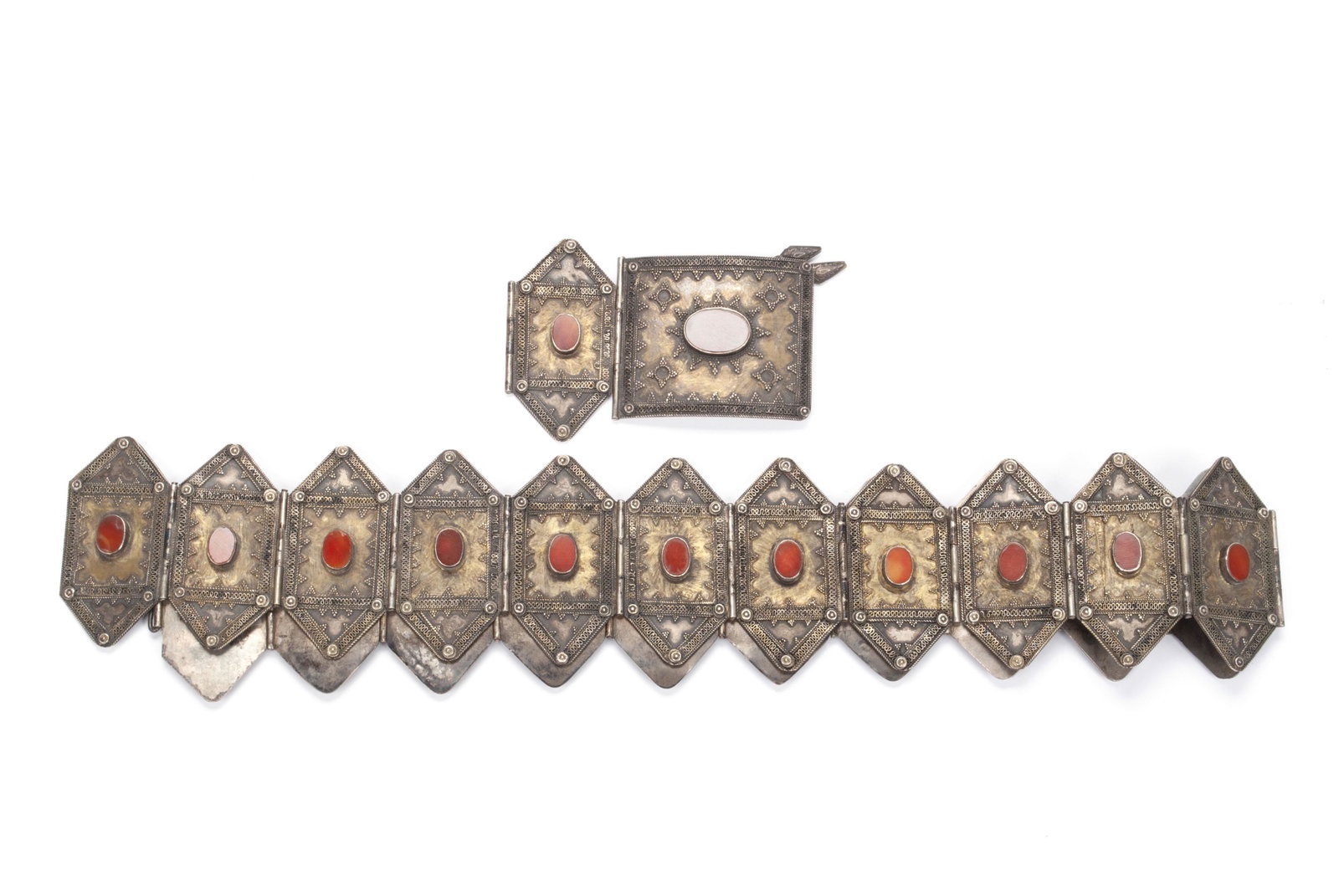 TURKOMAN SILVER AND CARNELIAN BELT: TURKOMAN SILVER AND CARNELIAN BELT Nineteenth century. Twenty-three panels of repousse and wire decorated silver with oval carnelians mounted to each, connected by hinges. 35" length