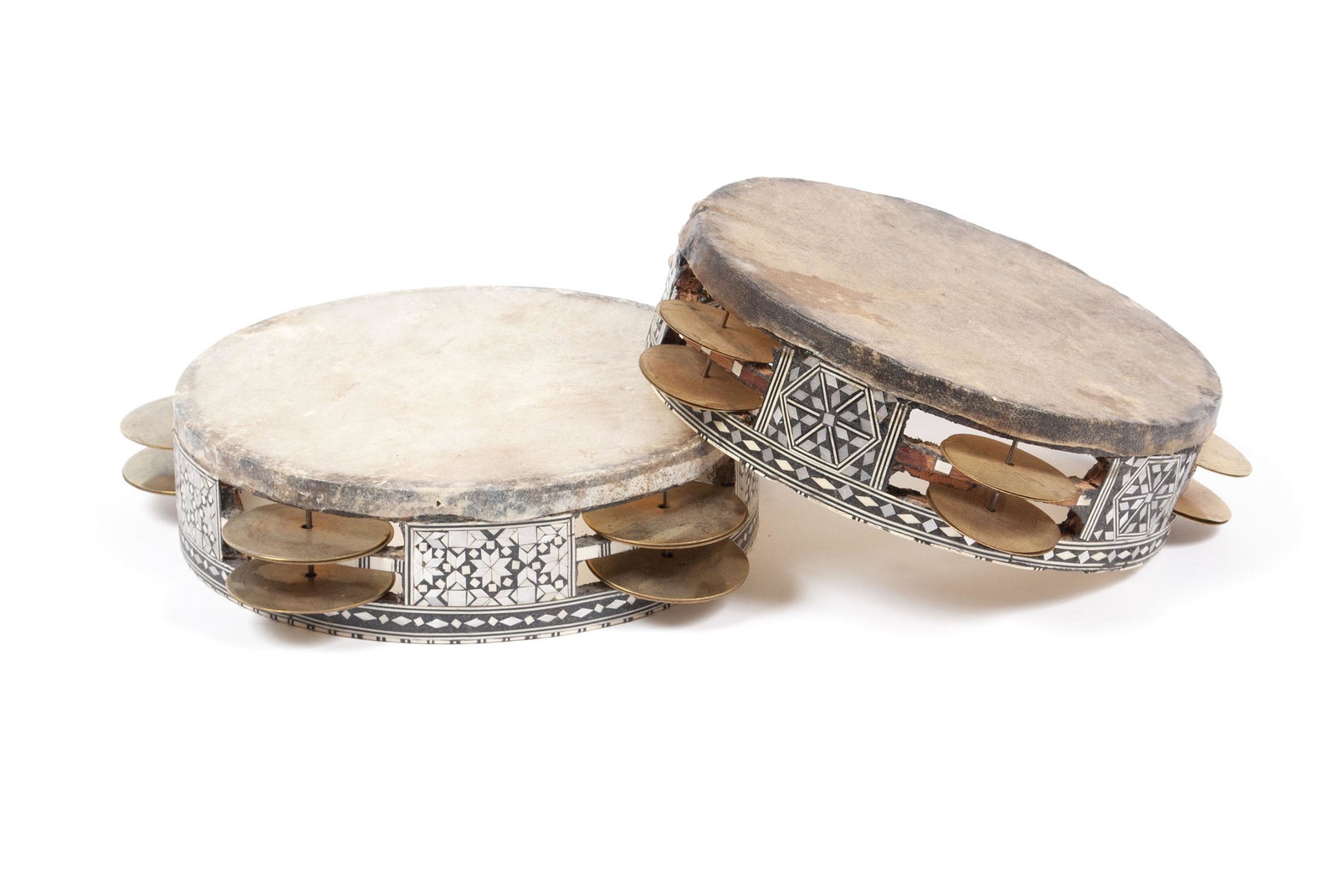 PAIR INLAID TRADITIONAL RIQ TAMBOURINES: PAIR INLAID TRADITIONAL RIQ TAMBOURINES Arabic, early 20th century. Intricate mother of pearl inlay patterns to the framework of each, one with a likely goat hide head, the other likely fish skin. Lar