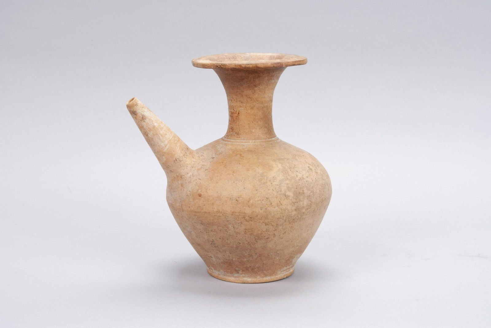 SAWANKHALOK STONEWARE KENDI: SAWANKHALOK STONEWARE KENDIThailand (Si Satchanalai), Unglazed tone ware drinking vessel having a globular body with a tall neck with flared rim. 8.5" height, 8" width, 6.25" depth
