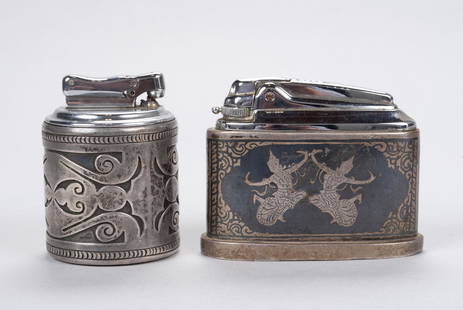 TWO SILVER TABLE LIGHTERS: TWO SILVER TABLE LIGHTERS One of elongated form, the case unmarked silver wrap having Siamese-inspired incised scene of warring elephants with two dancers to the other side with inset Ronson lighter,