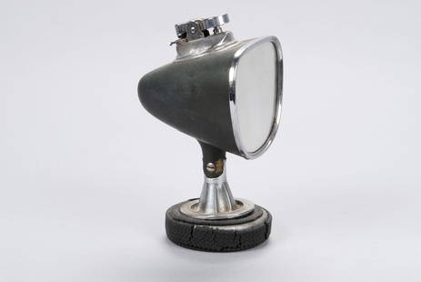 DUNLOP RACING SIDEVIEW MIRROR SHAPED CIGAR LIGHTER: DUNLOP RACING SIDEVIEW MIRROR SHAPED CIGAR LIGHTERWith gear shift button, hinged mirror form body mounted to rubber tire base. "M-15; Dunlop Racing; CR85" to underside. 6" height