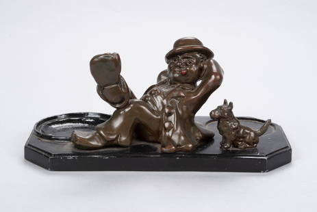 FIGURAL HOBO WITH DOG SMOKING TRAY: FIGURAL HOBO WITH DOG SMOKING TRAYAmerican, 20th century. Vintage bronze patinated spelter figure of hobo with lit cigarette and dog attached to black enameled spelter base, (spaces for possible