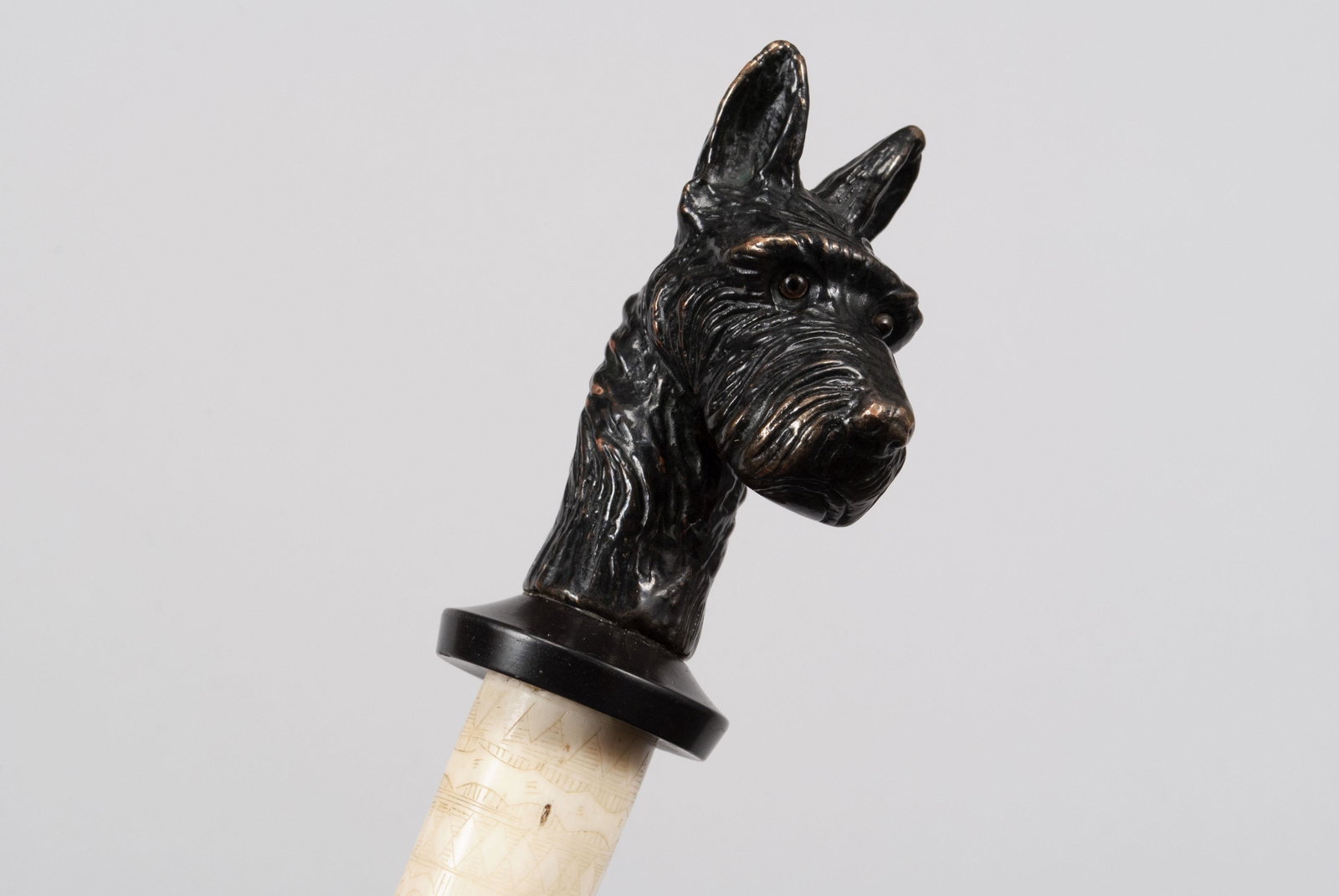 INTRICATE CARVED CANINE WALKING STICK/CANE: INTRICATE CARVED CANINE WALKING STICK/CANE Cold-painted copper finial in the form of a Scottish terrier dog with glass eyes, mounted to a banded and intricately carved shaft with dragon motifs, I Chin