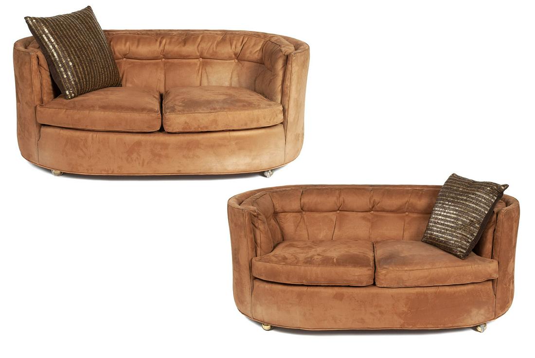 PAIR OF BROWN SUEDE LOVESEATS: PAIR OF BROWN SUEDE LOVESEATSAmerican, late 20th century. Oval form with button upholstered backs. 26" height, 60" width, 32" depth