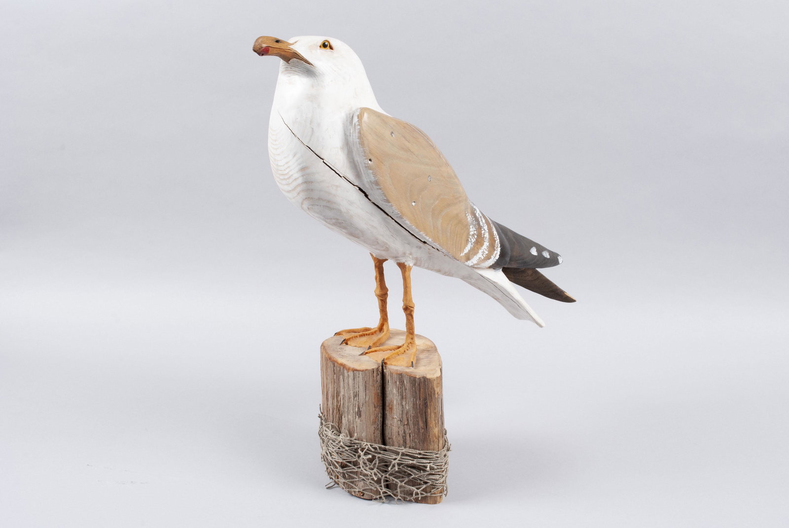 LANCE LICHTENSTEIGER (AMERICAN, 20TH CENTURY): LANCE LICHTENSTEIGER (AMERICAN, 20TH CENTURY)Carved and painted wood, signed to base with "Surf City, N.J." also inscribed. Glass-eyed statue of a proportionate seagull stood atop a rough wooden plint