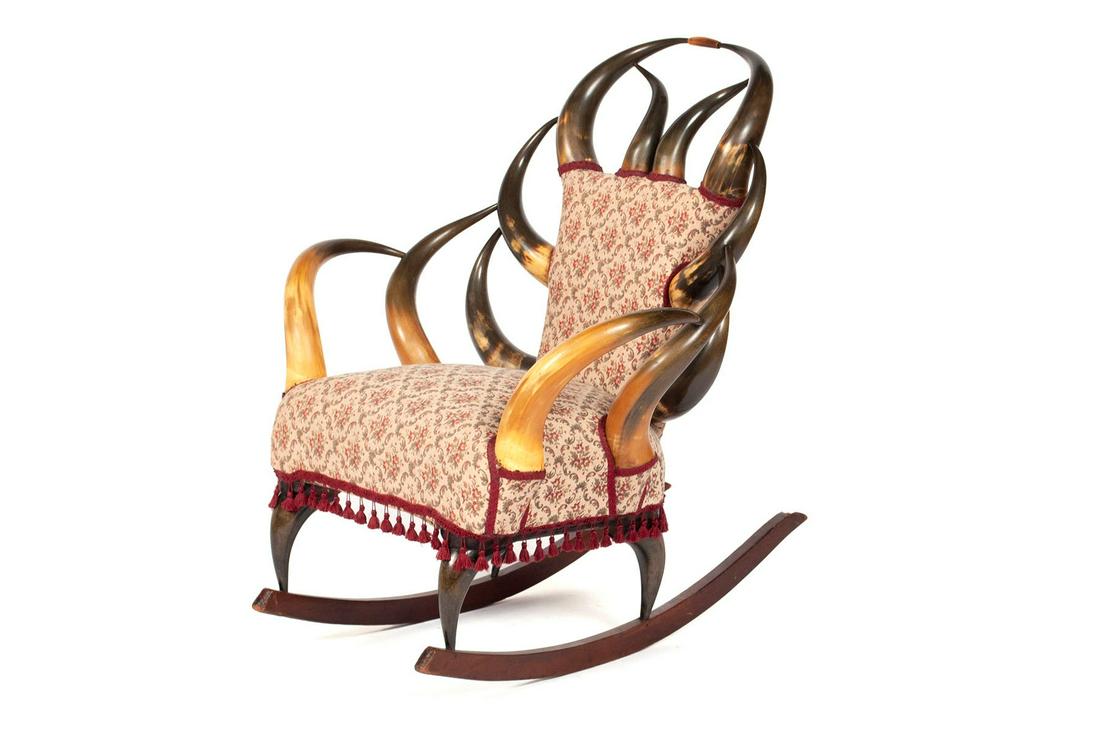 HORN ROCKING CHAIR: HORN ROCKING CHAIR American, late 19th century. Symmetrical form with twelve horns around the padded seat and back, and four horn legs, mounted on rocker rails. 36 in. x 31 in., seat 17 in.