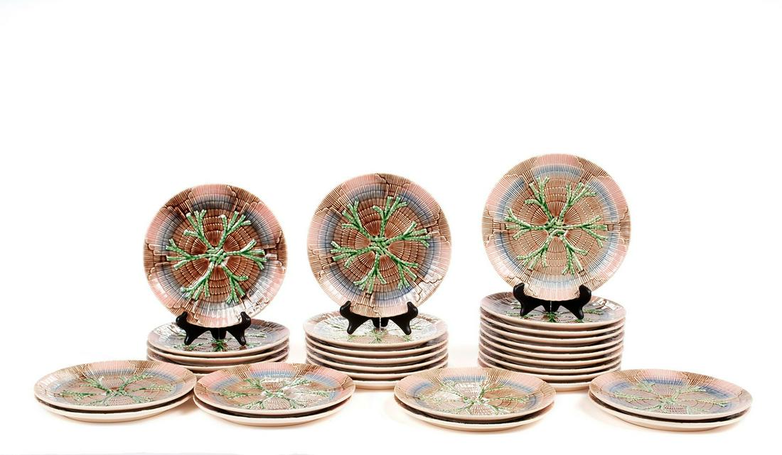 SET OF THIRTY BORDALLO PINHIERO MAJOLICA DINNER PLATES: SET OF THIRTY BORDALLO PINHIERO MAJOLICA DINNER PLATES Portuguese, all of a shell and seaweed pattern in relief, stamped appropriately to undersides. 10.25" diameters