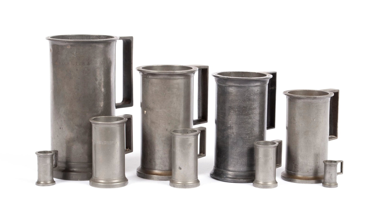 GRADUATED SET OF NINE FRENCH PEWTER MEASURES: GRADUATED SET OF NINE FRENCH PEWTER MEASURES France, mug form. Nine (9) total pieces, four marked J.R..