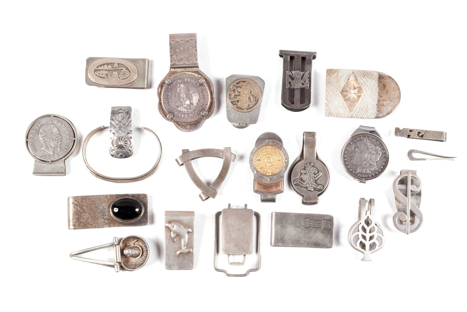 COLLECTION OF STERLING AND ARTISANAL MONEY CLIPS: COLLECTION OF STERLING AND ARTISANAL MONEY CLIPS Coins involved include an American 1898 Morgan silver dollar coin on clip, an 1878 Italian King Victor Emmanuel II silver 5 lire coin on clip (split in