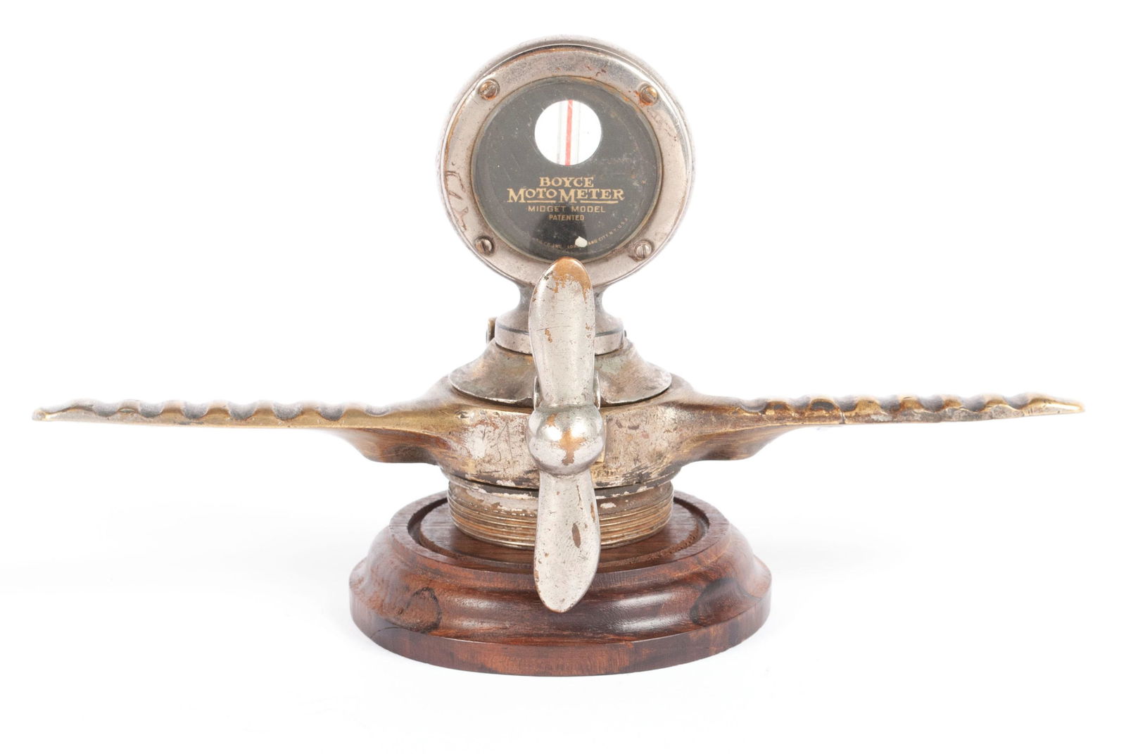 WINGED MOTOMETER WITH PROPELLER HOOD ORNAMENT RADIATOR CAP: WINGED MOTOMETER WITH PROPELLER HOOD ORNAMENT RADIATOR CAPBoyce Motometer mounted on the cap with propeller ornamentation, all atop the full width, gilt finished wings.4 1/4 x 9.10 in. (10.80 x 23.11
