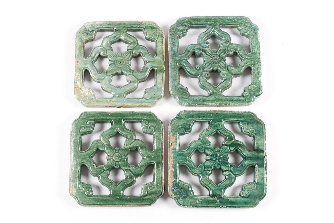 FOUR CERAMIC CHINESE VENTS: FOUR CERAMIC CHINESE VENTSPierced, floral designs to each ventilation or grill tile in jade green glaze.Each 13 1/2 in. square (34.29 cm.)