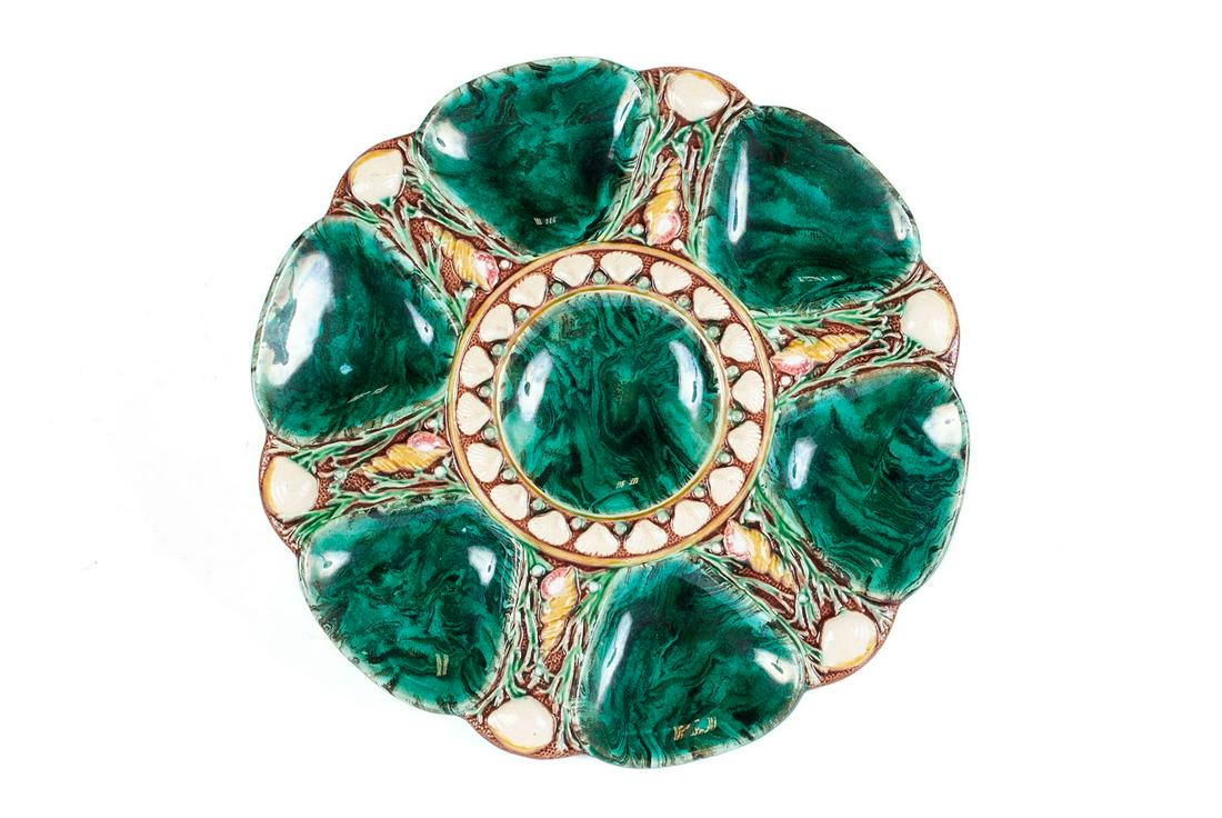 MAJOLICA OYSTER PLATE BY MINTON: MAJOLICA OYSTER PLATE BY MINTONWith marks including registry, Minton, #1323. Circa 1864. Marbled malachite-style glaze to the divots, accented with intricate and textured shell and seaweed design.Diam